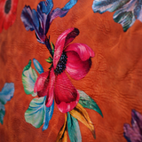 An up close image of the Orange Floral Print Italian Leather Crossbody Bag showing off its design.
