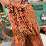 Close-up of bow tie detail on boho maxi silk dress