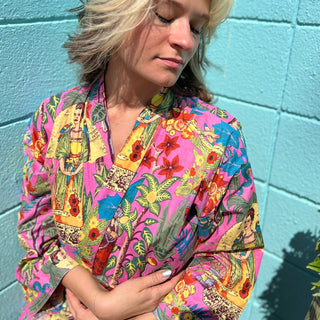 Side profile wearing Frida robe in soft lighting