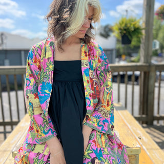 Full view of Frida kimono robe from front while seated outdoors