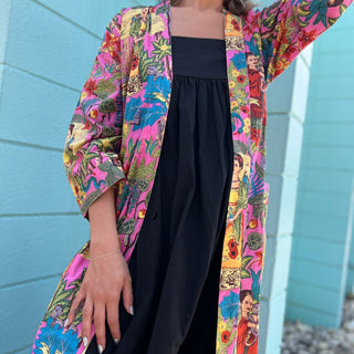 full front view of model wearing frida kimono with one hand on leg and 1 arm sticking up