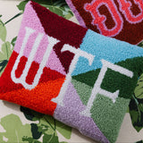 Funny needlepoint throw pillow styled on a couch as bold statement home decor