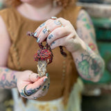Closeup of handmade mushroom crystal pendant necklace with recycled silk wrapping