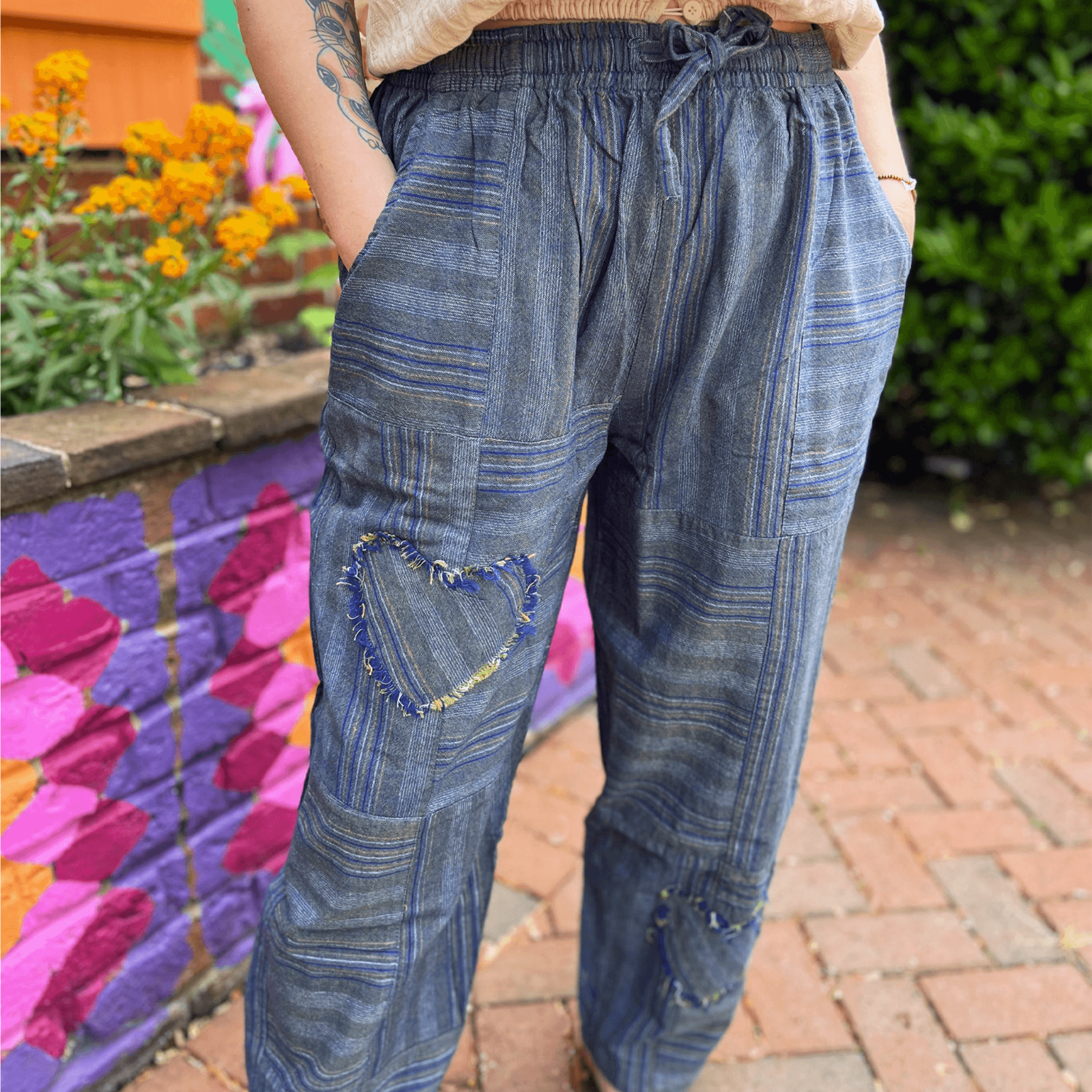 Model wearing heart patchwork barrel pants with striped cotton fabric and relaxed boho fit
