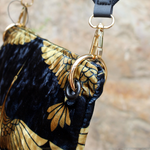 An up close image of the Small Black and Gold Heron Velvet Crossbody Bag.