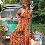 Model wearing rainbow psychedelic wide leg boho jumpsuit