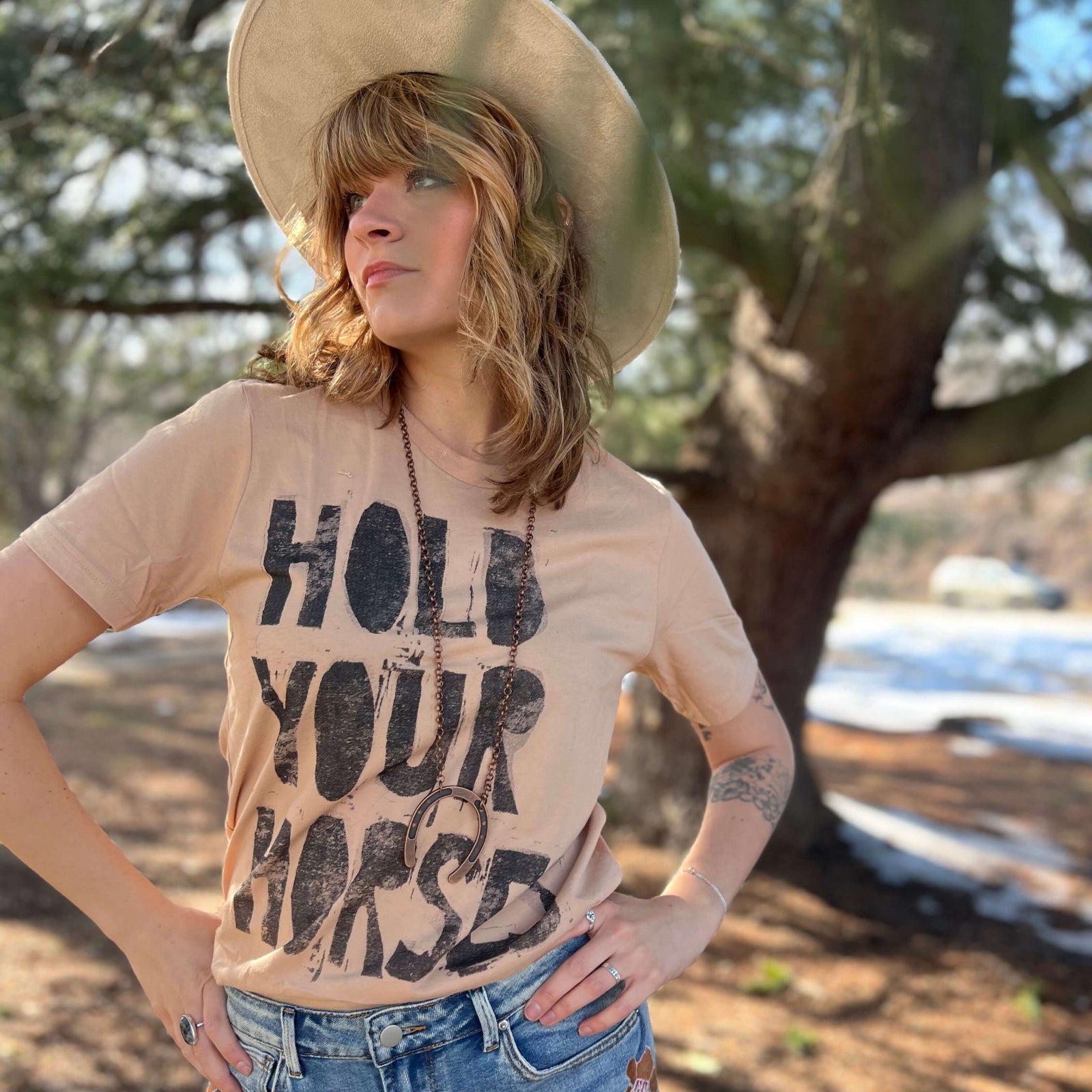 Vintage western Hold Your Horses t-shirt styled outdoors with relaxed boho vibe