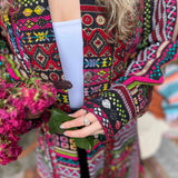 Detailed shot of festival boho trench coat woven cotton pattern