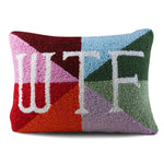 Close-up of needlepoint pillow with embroidered WTF lettering and textured stitching