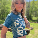 Close-up of lotus and Om symbol graphic on cropped boho t-shirt