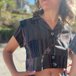 Close-up of wooden buttons on striped crop top