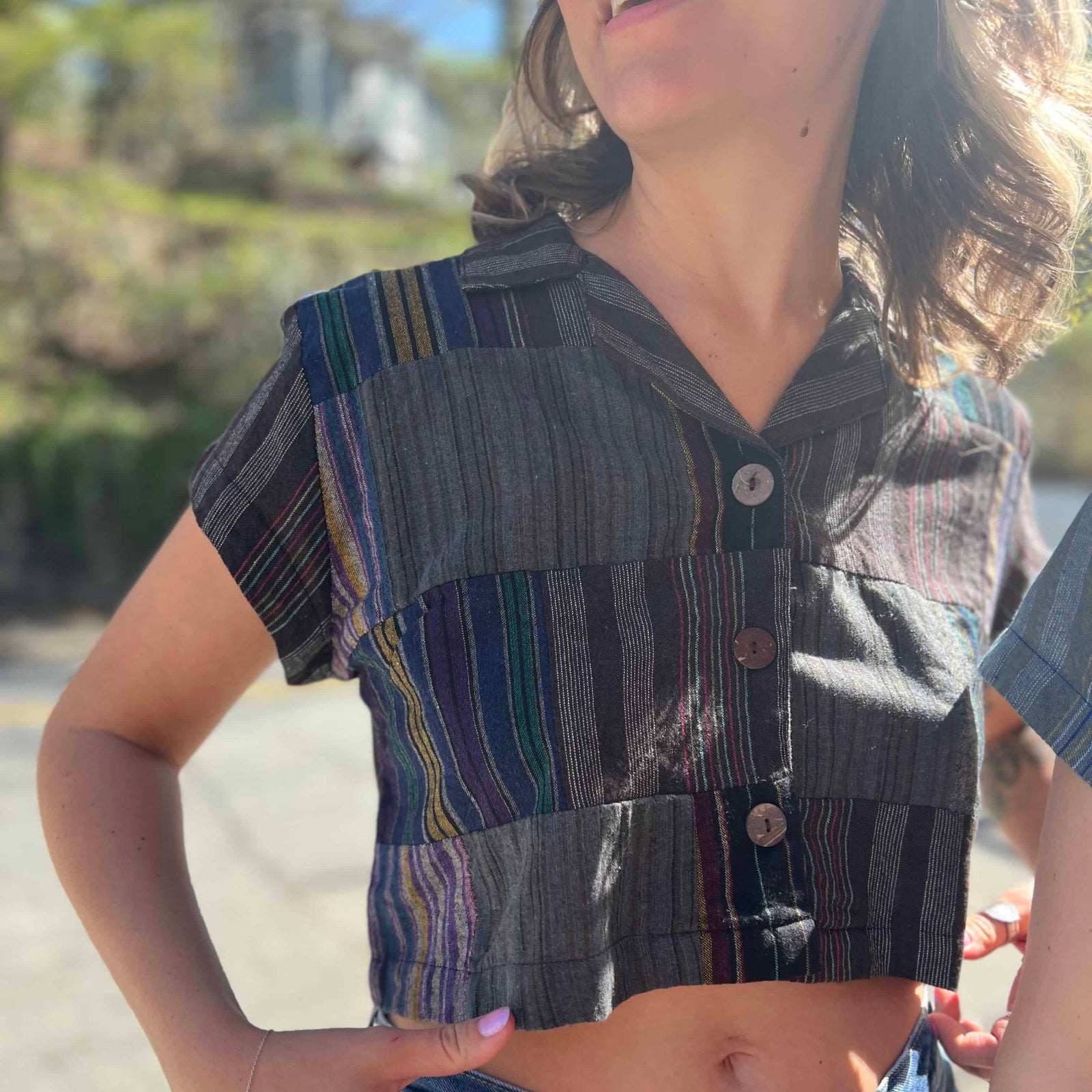 Close-up of wooden buttons on striped crop top
