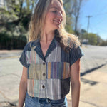 patchwork cropped blouse on model looking sideways with smile