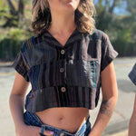 grey patchwork cropped blouse on model with blonde hair with stomach exposed