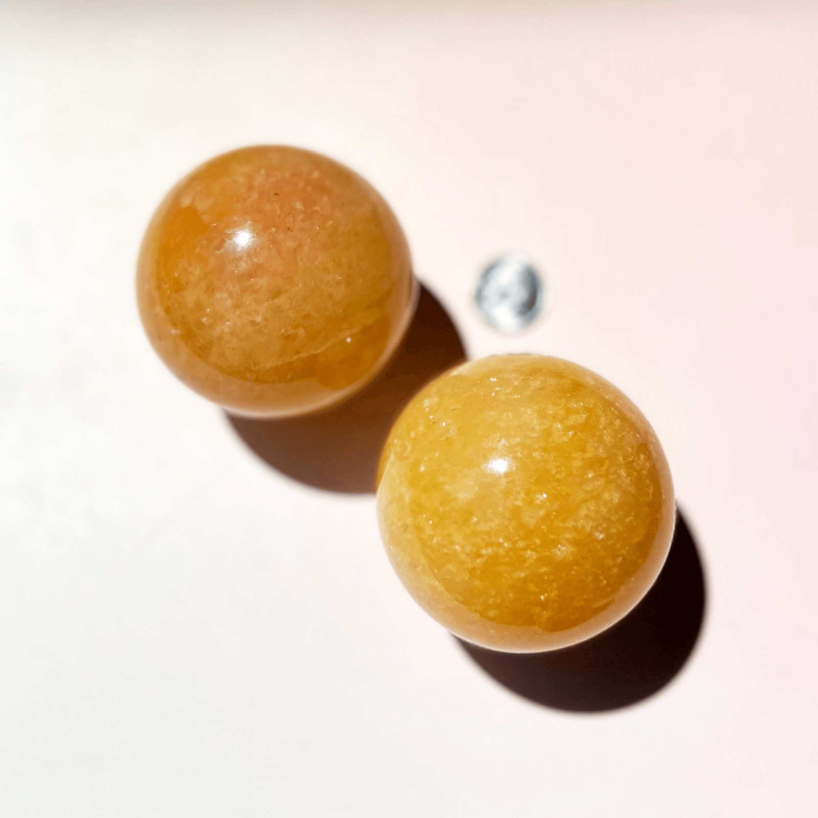 orange calcite sphere close up with creamy white swirls