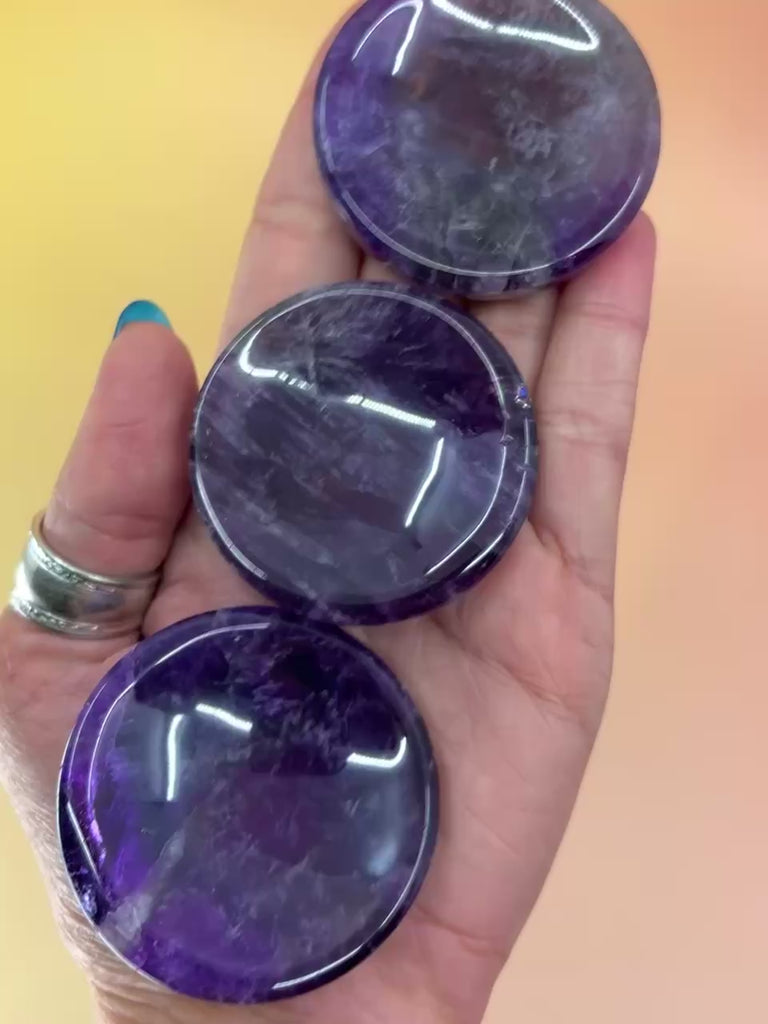Amethyst Crystal Sphere stand videos in hand showcasing 3 crystal stands