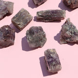 Mineral aragonite crystals on a pink background