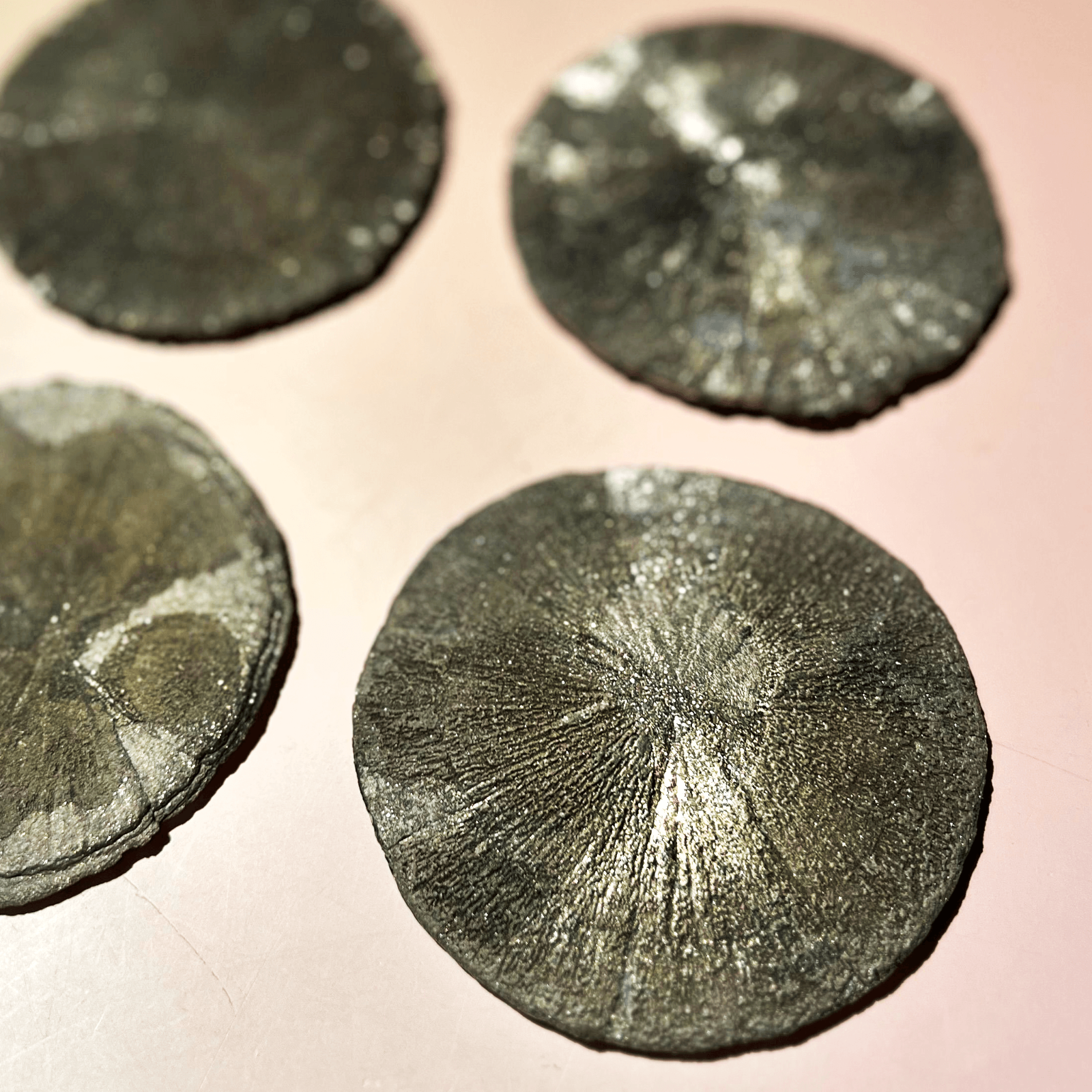 Collection of round pyrite sun crystals showing natural sunburst pattern and metallic texture
