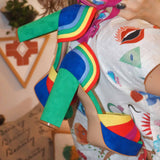 Side view of rainbow suede platform heels with peep toe and ankle strap.