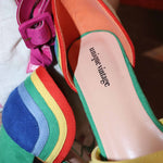 Rainbow suede peep toe pumps showing adjustable ankle strap detail.