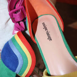 Rainbow suede peep toe pumps showing adjustable ankle strap detail.