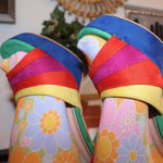 Closeup of rainbow suede peep toe pumps showing faux suede texture.