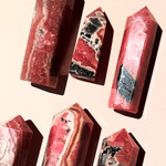 Close up of rhodochrosite crystal showing natural pink and cream banded patterns