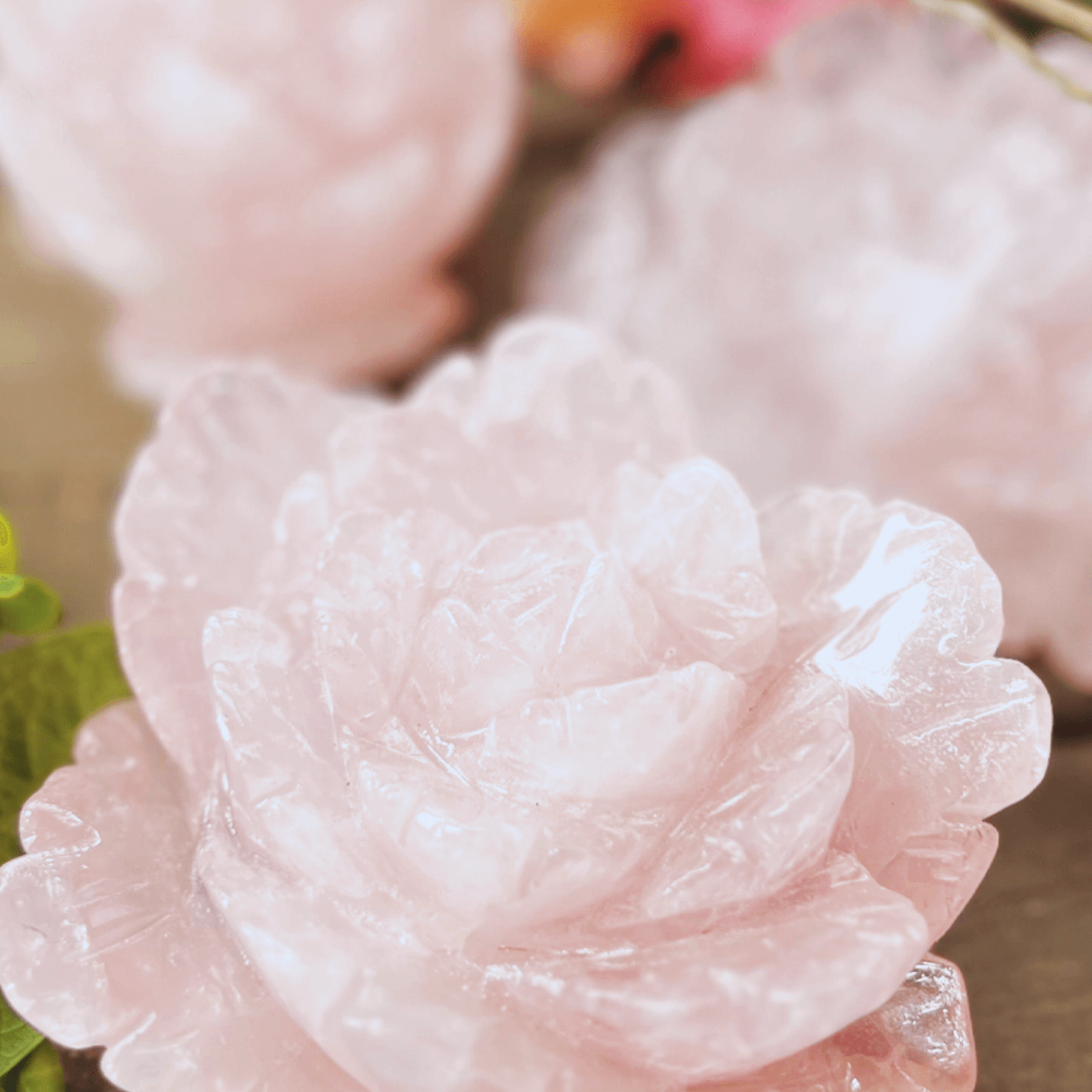 Collection of hand carved rose quartz crystal roses with natural pink gemstone glow