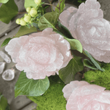 Rose quartz love crystal carved into a rose symbolizing compassion and emotional healing