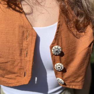 Rustic stripe fitted cotton vest - close-up of carved buttons on orange vest