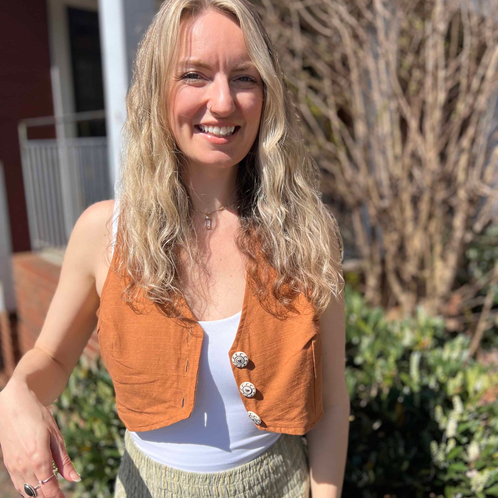 Rustic stripe fitted cotton vest - model smiling in sunshine wearing cotton vest