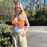 Rustic stripe fitted cotton vest - model outdoors showing vest with wide-leg pants and sandals