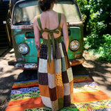 Sage green prairie dress featuring oversized patchwork pockets