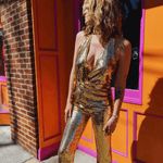 Close up of gold sequin halter neckline jumpsuit