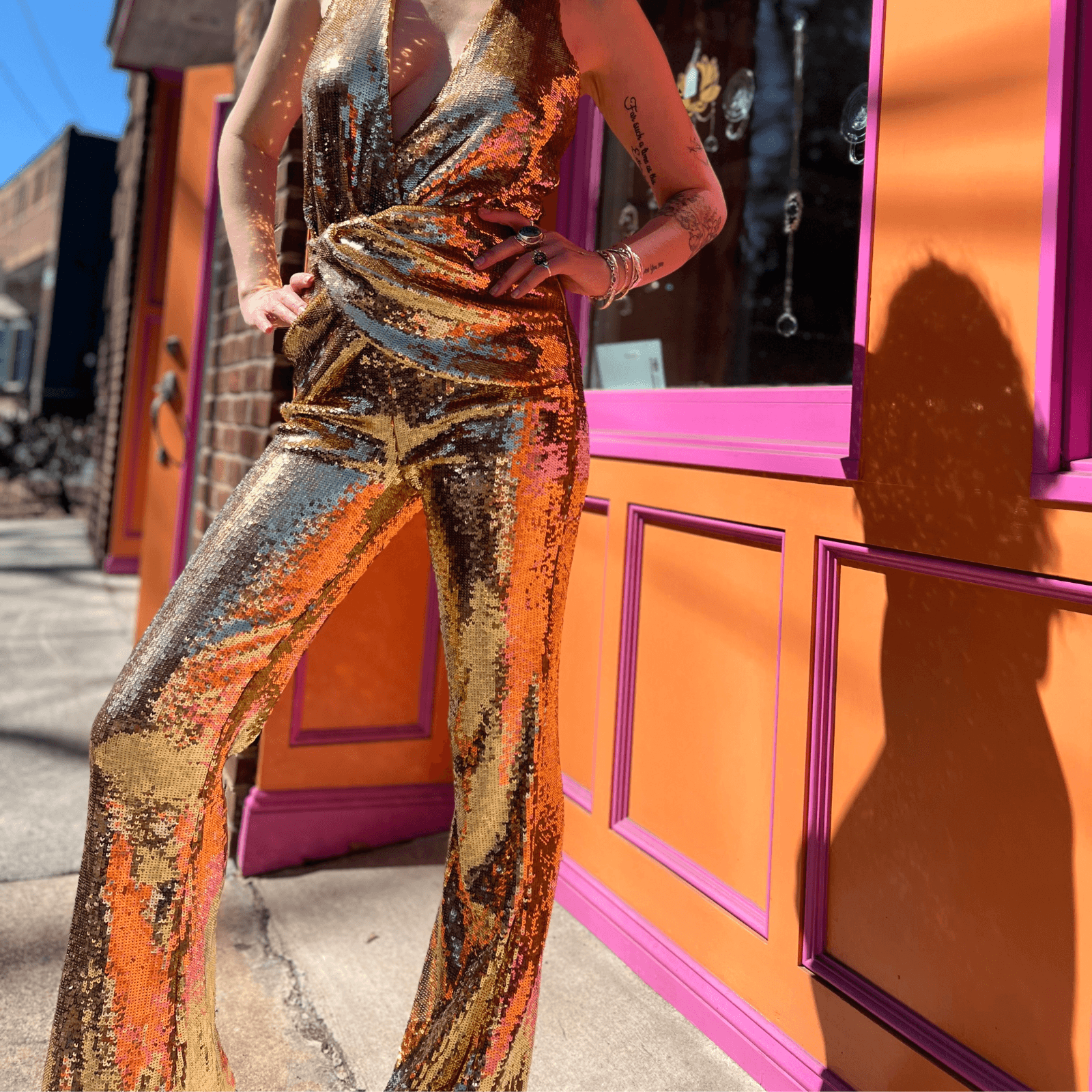 Gold disco jumpsuit reflecting light in party setting