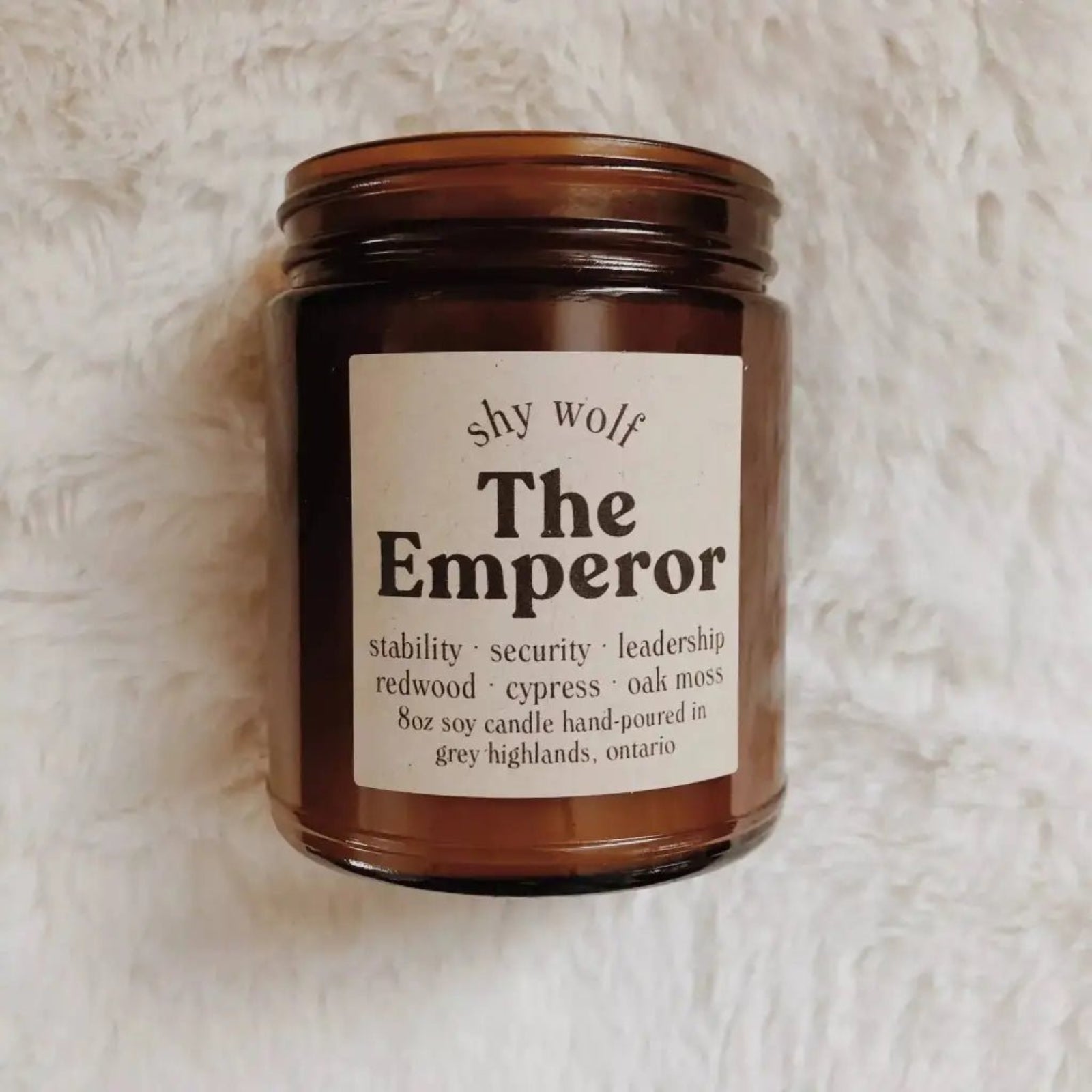 The Emperor candle on a white fluffy surface.