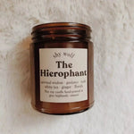 The Hierophant candle on a white fluffy surface.