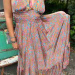 Person wearing a floral dress with a blurred background