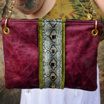 Someone holding the Distressed Blush Snakeskin and Leather Crossbody Bag.