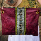 Someone holding the Distressed Blush Snakeskin and Leather Crossbody Bag.