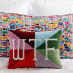 Statement needlepoint pillow with bold quote design styled as modern home decor