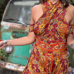 Petite model wearing XXS rainbow psychedelic jumpsuit