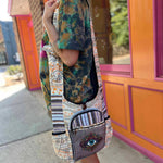 woman holding boho crossbody bag with embroidered eye