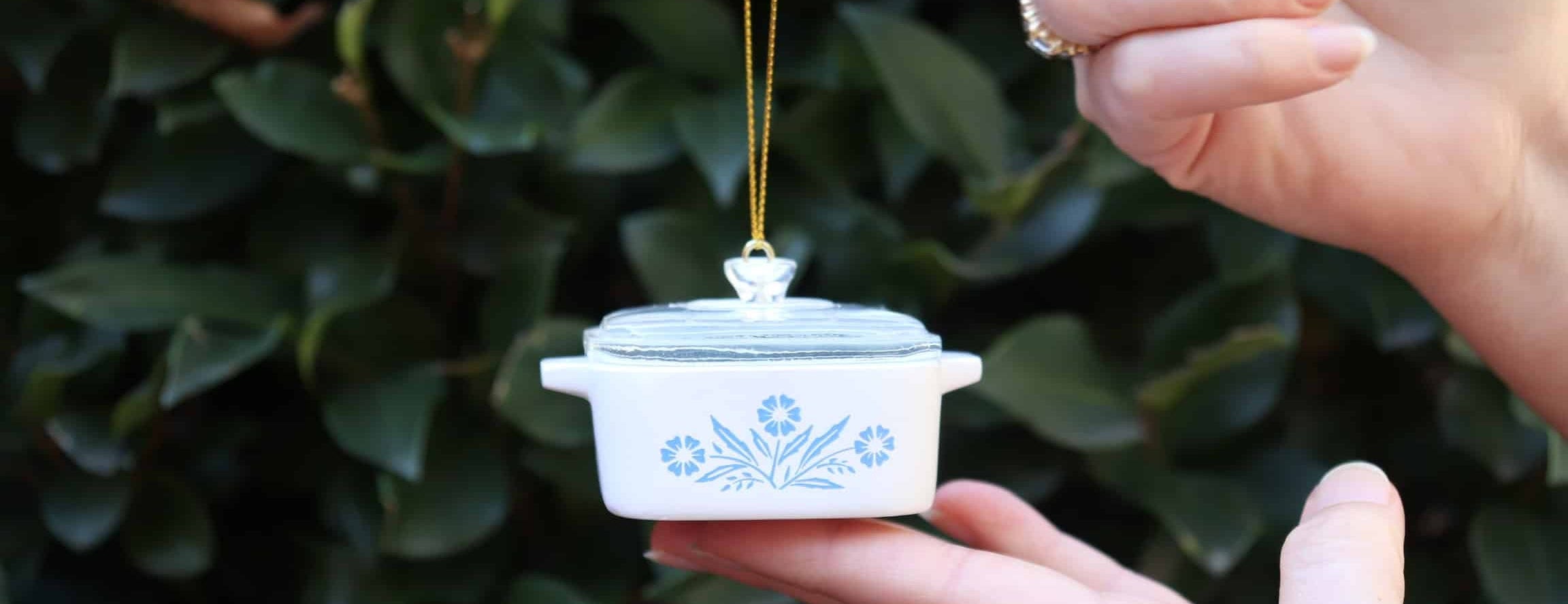 vintage ornament pyrex dish in front of green bush