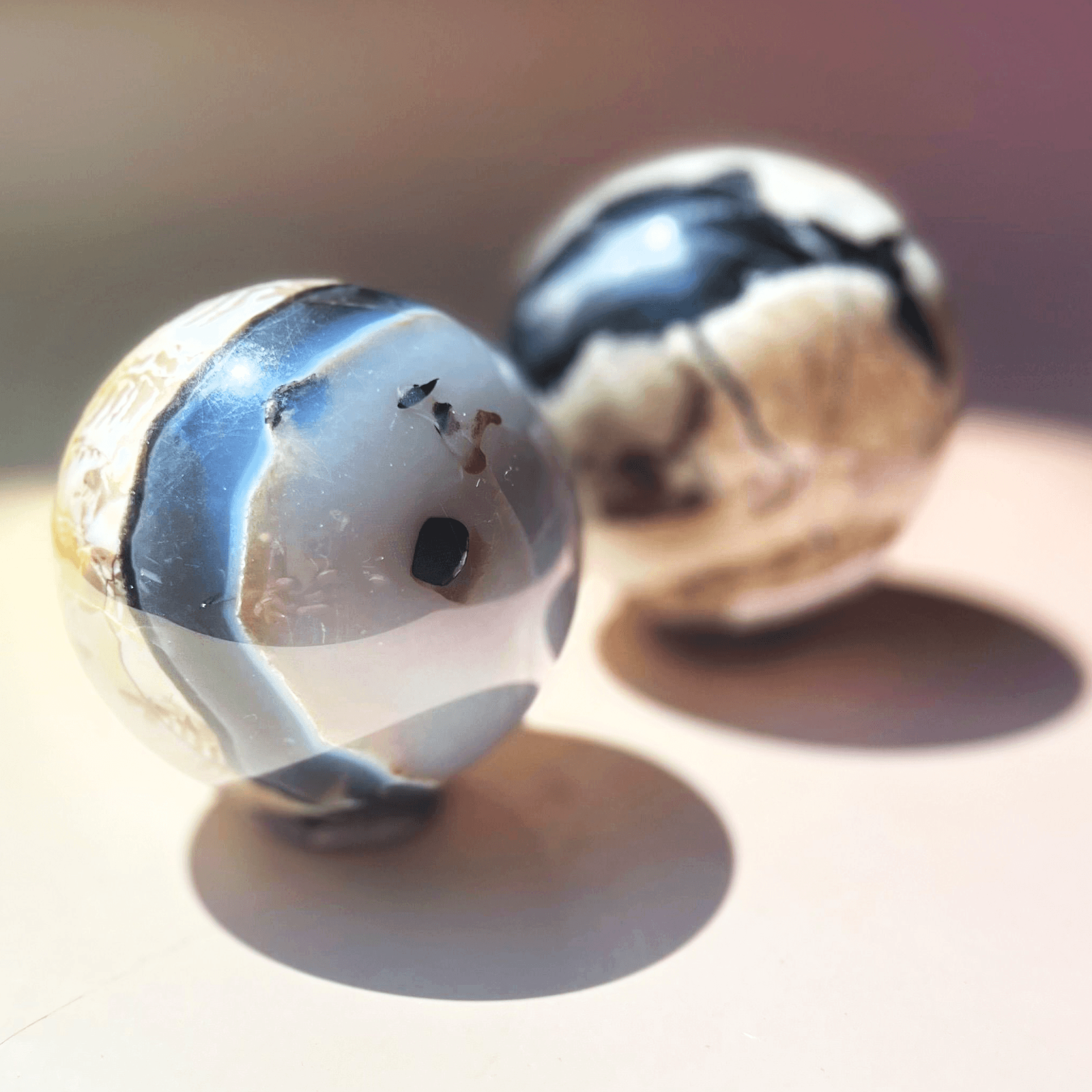 Natural volcano agate crystal sphere with black and cream banding polished gemstone ball