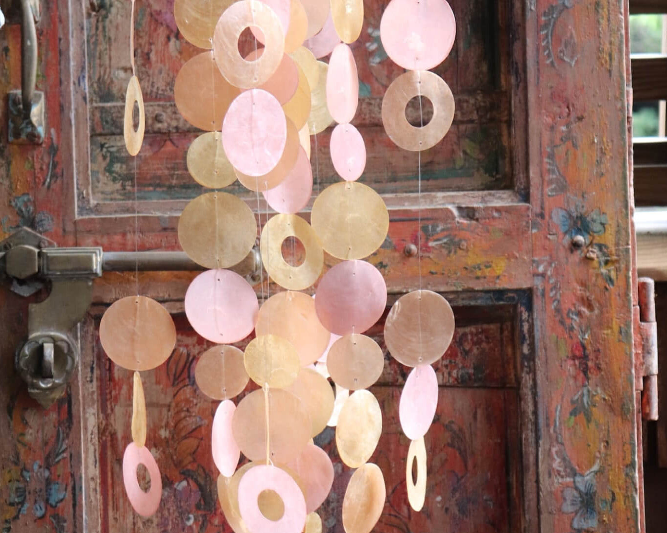 Assorted wind chimes including metal, bamboo, and wooden wind chimes