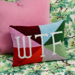 WTF needlepoint pillow shown at 12x16 inches for size reference on a chair