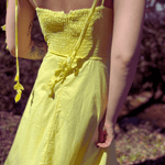 Full body view of yellow summer midi dress with flowy skirt