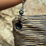 An up close image of the Distressed Black and Tan Bengal Stripe Crossbody Bag.
